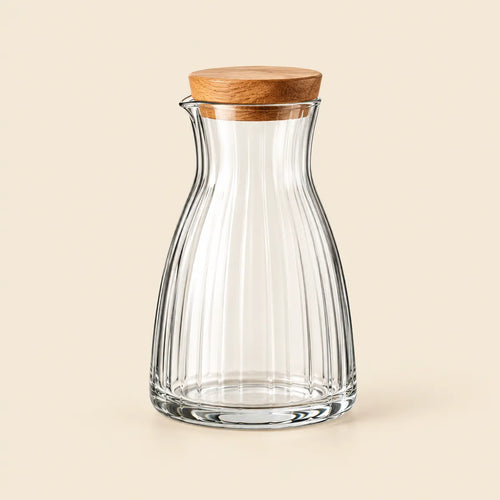 Verdelique clear fluted glass carafe with natural-wood stopper on an ivory background