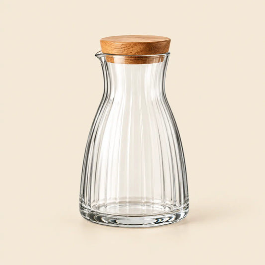 Verdelique clear fluted glass carafe with natural-wood stopper on an ivory background
