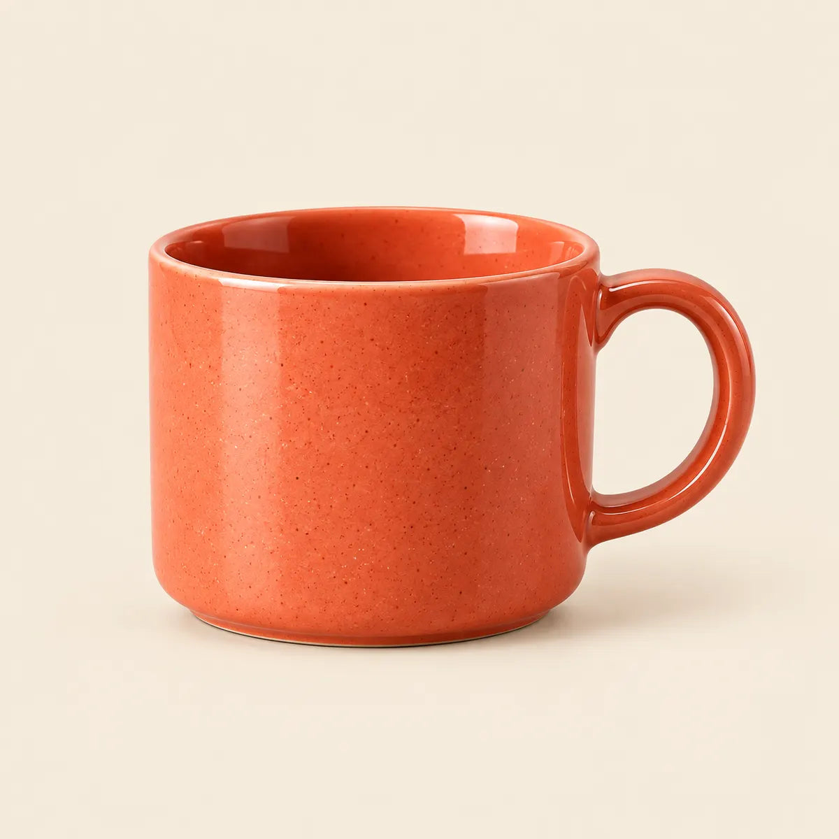 Verdelique coral-orange speckled mug on a warm ivory background
