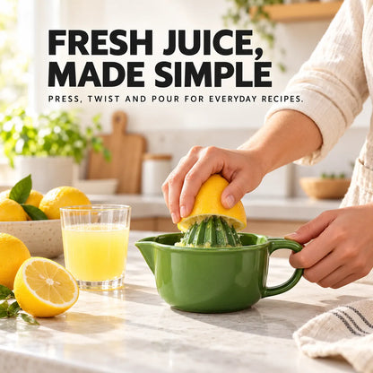 Olive green manual citrus juicer being used to press a fresh lemon